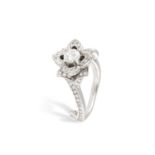 A DIAMOND DRESS RING, designed as a flower, set with a brilliant-cut diamond at the centre, to a