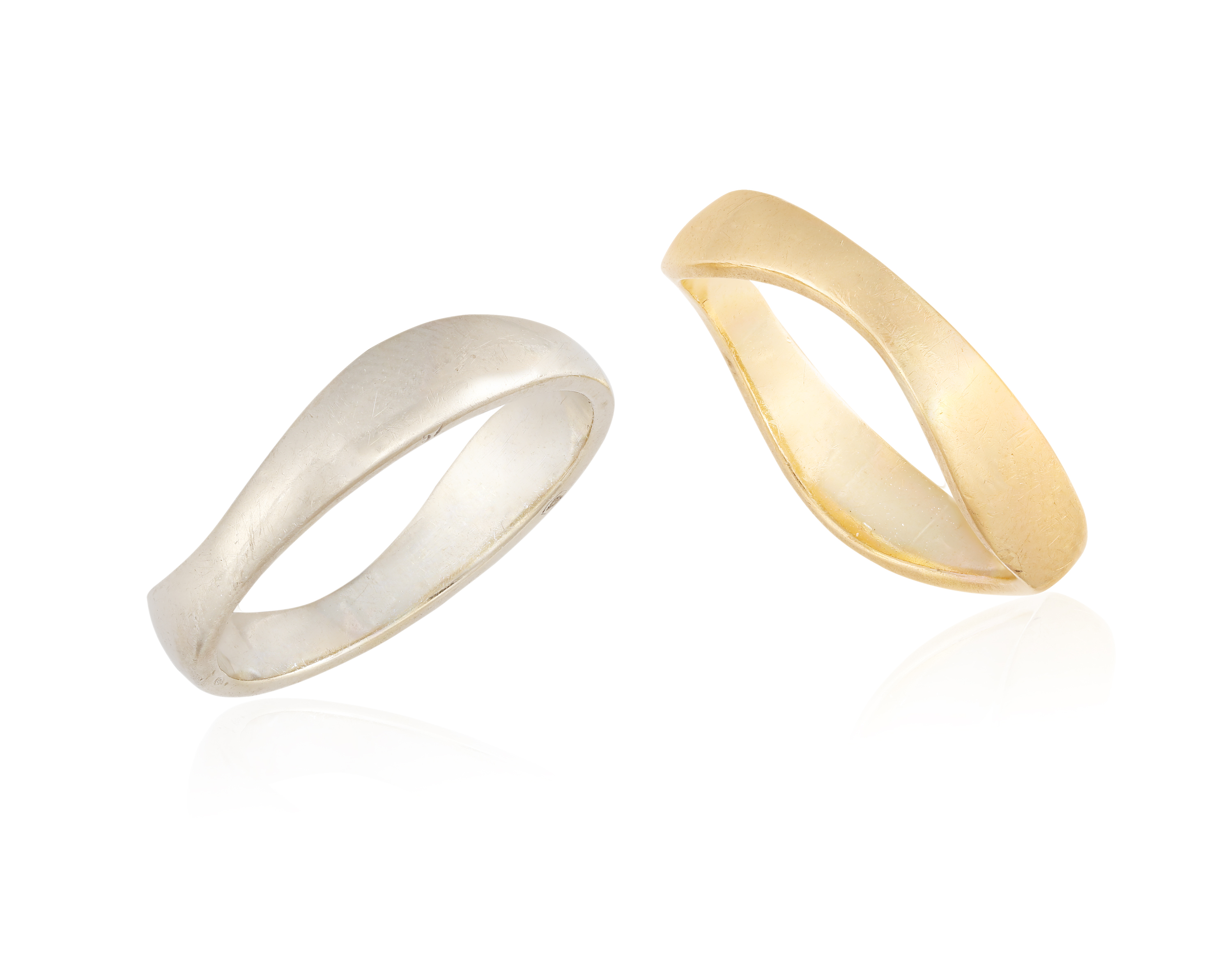 TWO GOLD RINGS, of wavy design, one mounted in 18K white gold, and the other mounted in 18K yellow