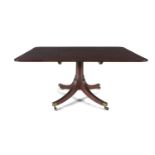 A REGENCY MAHOGANY TILT-TOP BREAKFAST TABLE, the squared top with rounded corners over a solid