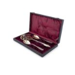 A CONTINENTAL SILVER GILT SERVING SET, 19th century, comprising of a slice and two spoons, in fitted