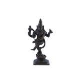 A BRONZE FIGURE OF NATARAJA, modelled in dancing pose, with fire in his upper left hand and the