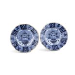 A PAIR OF FRENCH FAIENCE CIRCULAR DISH CHARGERS, decorated with foliate motifs in blue and white and