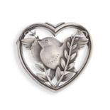 A SILVER BROOCH BY GEORG JENSEN, CIRCA 1933-44, the heart-shaped frame enclosing a stylised bird