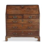 A GEORGE III MAHOGANY SLOPEFRONT BUREAU, with well fitted interior raised above two short and