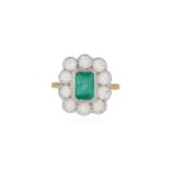 AN EMERALD AND DIAMOND CLUSTER RING, the cut-cornered rectangular-cut emerald within collet-setting,