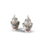 A PAIR OF MEISSEN BALUSTER URNS AND COVERS, with cherub finials, encrusted with floral swags and