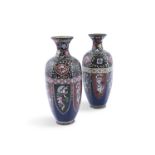 A PAIR OF JAPANESE CLOISSONE VASES, c. 1920, each of panelled ovoid shape withy flowered rims,