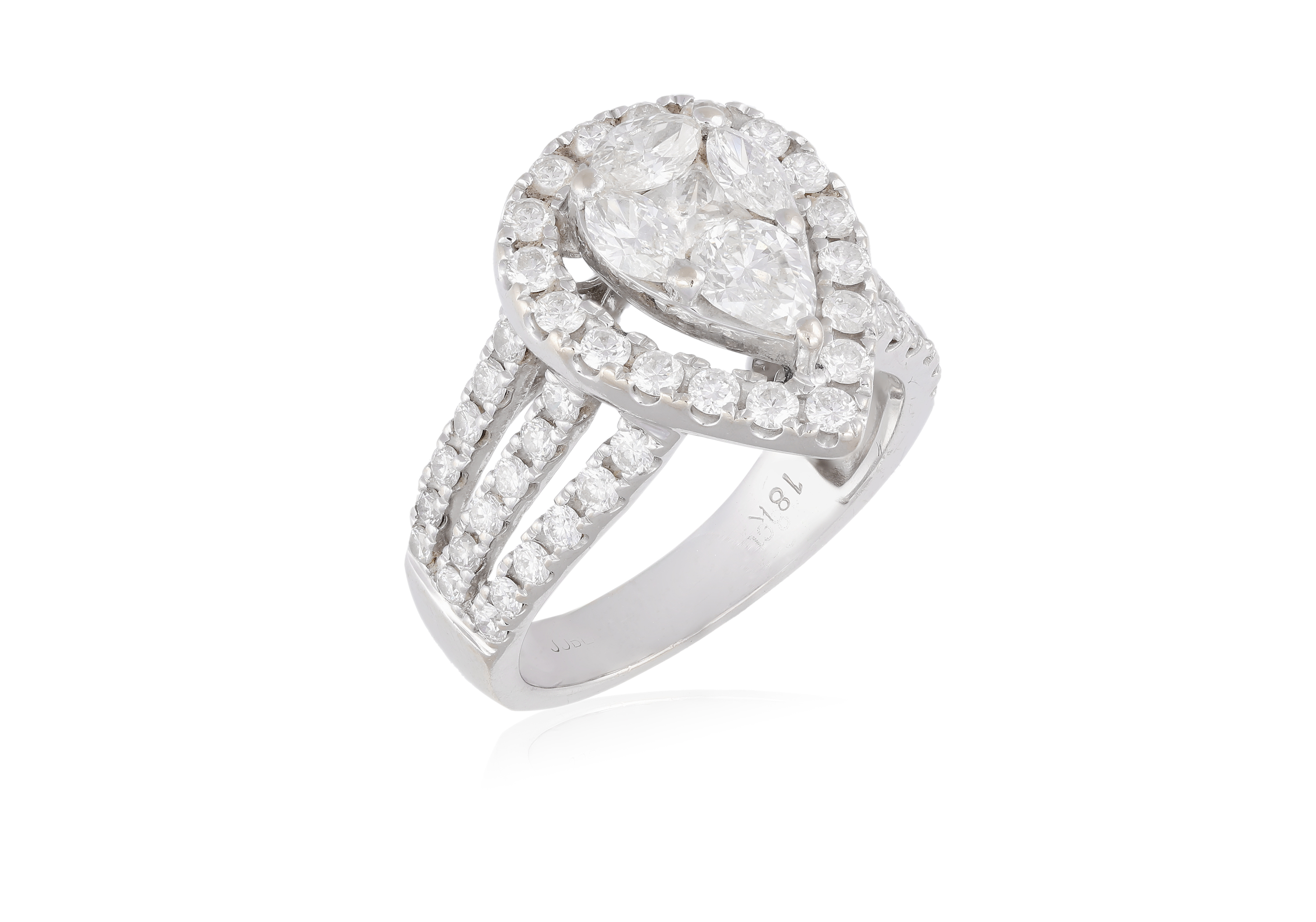 A DIAMOND DRESS RING, composed of a pear-shaped plaque set with a marquise, pear and princess-cut