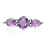 A VICTORIAN AMETHYST AND DIAMOND BROOCH, the central cushion-shaped amethyst between two oval-shaped