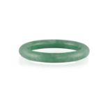 A JADEITE JADE BANGLE, the translucent jadeite bangle of green hue, suffused with white patches,