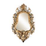 AN EARLY 19TH CENTURY GILTWOOD AND GESSO WALL MIRROR IN THE ROCOCO TASTE, the shaped oval plate