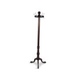 A GEORGE IV STYLE MAHOGANY HAT AND COAT STAND, raised on tripod supports with paw feet