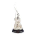 A JAPANESE CARVED IVORY OKIMONO, Meiji period (1868 -1912), modelled as a fisherman seated holding a