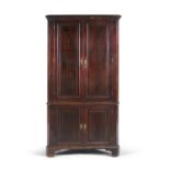 A GEORGE III MAHOGANY CORNER CUPBOARD, with moulded cavetto cornice above twin fielded panel