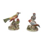 A PAIR OF CONTINENTAL PORCELAIN BIRD GROUPS OF WOODPECKERS, painted in green, red, blue and brown