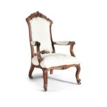 A VICTORIAN WALNUT FRAMED OPEN ARMCHAIR, with carved crest rail, with scrolling armrests, the padded