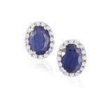 A PAIR OF SAPPHIRE AND DIAMOND EARSTUDS, each oval-shaped sapphire within a surround of brilliant-