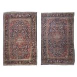 A PAIR OF FINE PERSIAN NAVY GROUND WOOL CARPETS, each of rectangular form with central lozenge