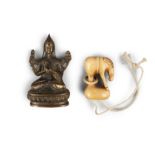 A JAPANESE IVORY NETSUKE, 19th century, in the form of a horse, standing on an oval mound with a