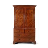 A VICTORIAN MAHOGANY BOW-FRONT LINEN PRESS, with stepped cornice above twin fielded panel doors