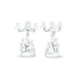 A PAIR OF GERMAN BLANC DE CHINE PORCELAIN FIGURAL CANDELABRA, each with four scroll arm branches and