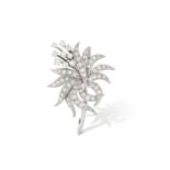 A DIAMOND FLOWER BROOCH, designed as a floral spray, the petals and leaf set with claw-setting