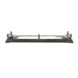 A VICTORIAN STEEL AND BRASS RAIL FENDER, the brass tubular top rail above urn shaped supports,