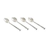 A SET OF FOUR 'OMAR RAMSDEN' SILVER COFFEE SPOONS, London 1908, each with flowerhead finial and