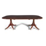 A MAHOGANY TWIN PILLAR EXTENDING DINING TABLE, 19th century of rectangular form with rounded