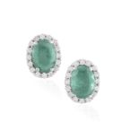 A PAIR OF EMERALD AND DIAMOND EARSTUDS, each oval-shaped emerald weighing approximately 0.45ct each,