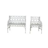 A VICTORIAN GOTHIC PATTERN WHITE PAINTED CAST IRON GARDEN SEAT; and a single chair en suite. The