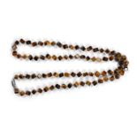 A TIGER'S EYE NECKLACE, composed of a single row of 3D square tiger's eye beads, to a white metal