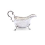 A GEORGE II IRISH SILVER SAUCEBOAT, lacking date letter, maker's mark rubbed, of helmet form, with