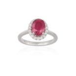 A RUBY AND DIAMOND DRESS RING, the oval-shaped ruby weighing approximately 2.20cts, within a