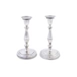 A PAIR GERMAN OR ITALIAN WHITE METAL CANDLESTICKS, each with flared nozzles and sockets, a