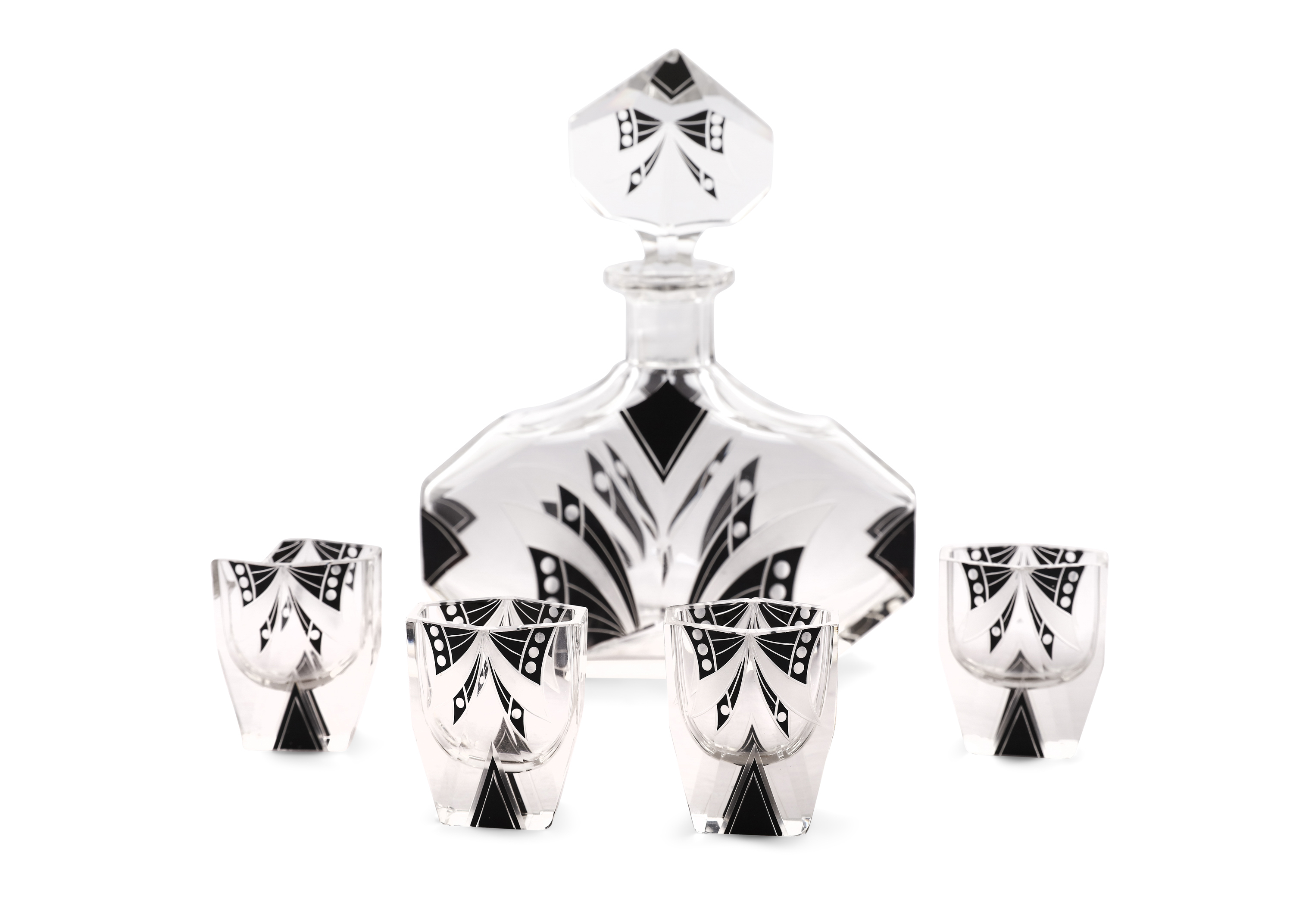 AN ART DECO BLACK AND CLEAR GLASS DECANTER SET, c.1930, of lozenge design, with flat cut stopper and