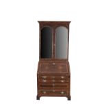 A GEORGE II STYLE INLAID WALNUT BUREAU BOOKCASE, the moulded cornice above twin mirror panel doors