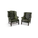 TWO MAHOGANY FRAMED LEATHER UPHOLSTERED LIBRARY ARMCHAIRS, each with button back seats and close