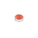 A CORAL AND DIAMOND RING, the oval-shaped cabochon coral set between brilliant-cut diamond