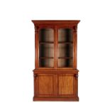 A VICTORIAN MAHOGNAY TWO DOOR BOOKCASE, the top section with moulded cornice above twin glazed