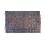 A SEMI ANTIQUE PERSIAN CARPET, the central reserve filled with flower heads and leafy sprays against