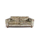 A TWO-SEATER FLORAL PATTERNED COUCH BY LINLEY, upholstered in biscuit beige fabric with floral