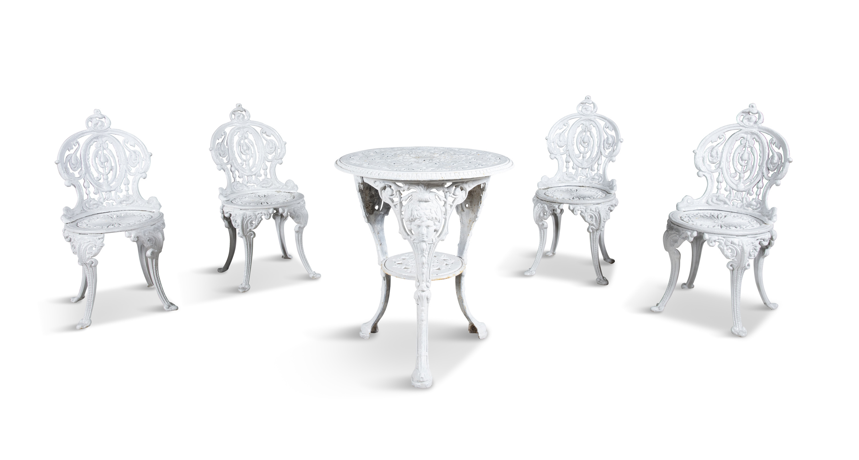 A WHITE PAINTED CAST IRON GARDEN TABLE AND FOUR CHAIRS, the table with pierced circular geometric