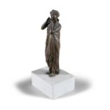 A BRONZE SCULPTURE OF A LADY, on white marble base
