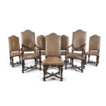 A SET OF EIGHT OAK FRAMED UPHOLSTERED CHAIRS, in the Dutch 17th century style, each with arched