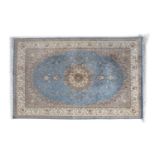 A PERSIAN BLUE GROUND WOOL CARPET, the rectangular centre field with circular medallion tendrils and