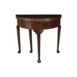 AN IRISH GEORGE II MAHOGANY FOLD-TOP D-SHAPED TABLE, with gate leg action support and plain frieze