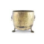 A LARGE BRASS FUEL BUCKET, 19TH CENTURY of cylindrical shape applied with twin lion mask and ring