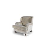 A MODERN HOWARD STYLE ARMCHAIR, upholstered in cream modern fabric, raised on turned front