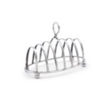 A GEORGIAN STYLE SEVEN BAR SILVER TOAST RACK, Sheffield 1920, mark of Joseph Rodgers & Sons, of oval